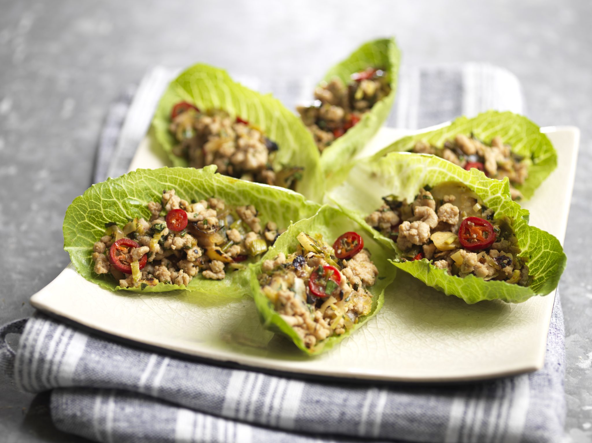 Southeast Asian Chicken Larb with Mann’s Shredded Brussels Sprouts in RomaCrunch® Cups - Foodservice